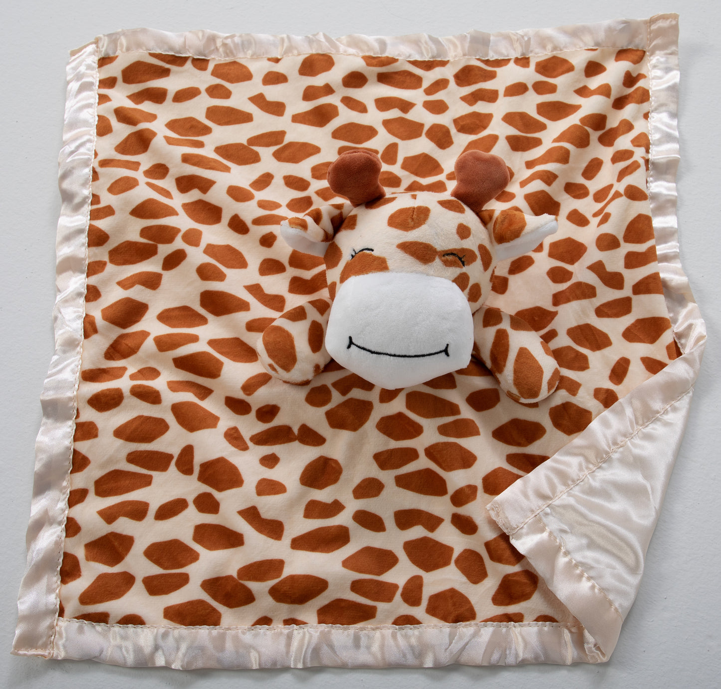 Our adorable stuffed giraffe lovey and security blanket companion is the perfect cuddly friend for your baby. Crafted with love, it's sure to provide comfort and companionship throughout the early years.  Made of soft plush and lined with satin, this lovable animal is sure to be your baby's new best friend.